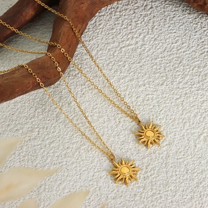 18K gold plated sun pendant necklace made of high-quality titanium steel on wood