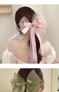 Macro detail of oversized layered organza bow hair clip with pearls for thick hair