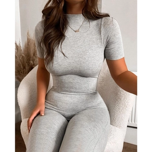 Close-up of light grey slim fit jumpsuit with mock neck and textured knit fabric