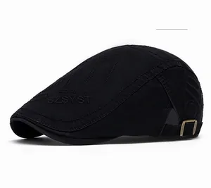 Detailed side view of black newsboy cap featuring side embroidery and metal buckle
