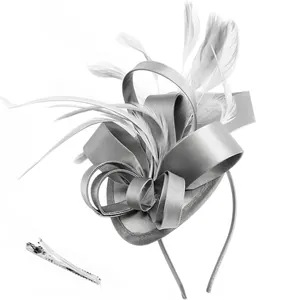 Macro detail of elegant grey satin bow and feather fascinator with headband and hair clip