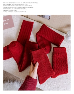 Close-up of thick red Christmas socks featuring cable knit and ribbed textures