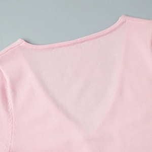 Detailed close-up of the V-neckline and fine knit texture on this pink summer dress