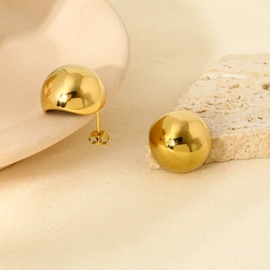 Polished 16K gold-plated stainless steel semi-circle stud earrings on a ceramic dish