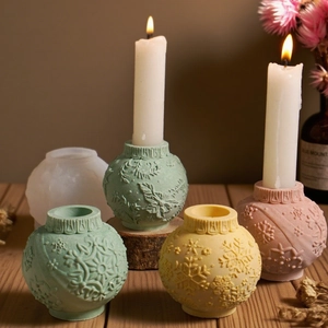 Spherical silicone mold and finished embossed snowflake resin candle holders on wood