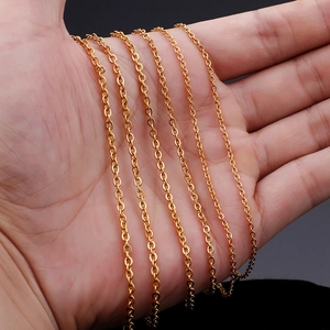 18K gold plated stainless steel O-chain necklaces held in hand for detail display
