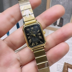 Macro view of GoGoey rectangular gold watch with black dial and Roman numerals