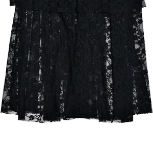 Detail shot of black lace hem and pleated fabric texture on a sexy fishtail maxi dress