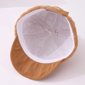 Detail of baby corduroy baseball cap showing white quilted lining and stitched inner band