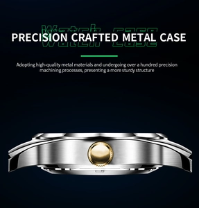Detailed close-up of silver brushed metal watch case with gold gear crown
