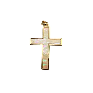 Cross pendant with iridescent shell inlay and golden metal frame on white background