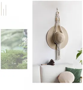 Detail of handcrafted macrame hat organizer with wooden beads and long tassels