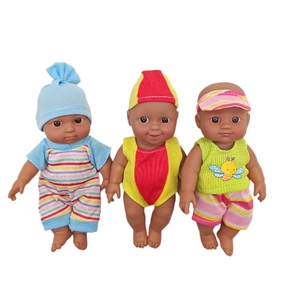 Detailed shot of three black vinyl baby dolls wearing colorful striped outfits and swimwear