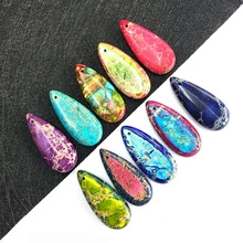 Macro shot of assorted teardrop stone pendants with unique marble textures for DIY jewelry