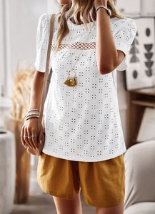 Detail of white short sleeve top featuring hollow embroidery and V-shaped lace splicing