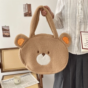Close-up of fluffy bear shaped tote bag in brown plush fabric with cute embroidery