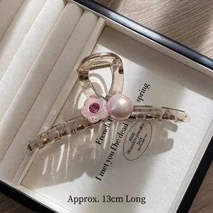 Detail of 13cm jelly flower shark clip with large pearl and pink floral accents