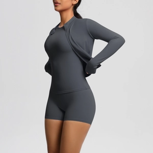 Detailed side view of high-stretch dark grey yoga set with zip jacket and slim shorts