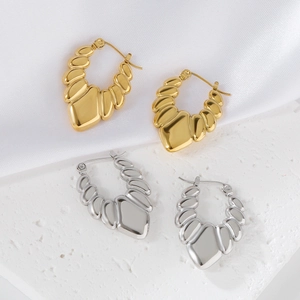 Detail showing gold and silver hoop earrings with unique fan-shaped pleated texture