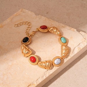 Detail of vintage gold bracelet with colorful geometric stones and lobster clasp closure