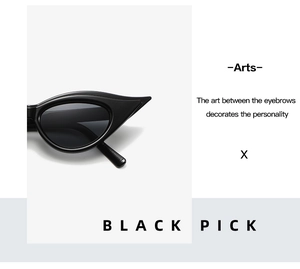 Detail of vintage cat-eye sunglasses with sharp winged black frame and glossy finish