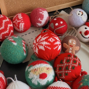 Close-up of handmade Christmas felt balls with reindeer, snowmen and festive patterns