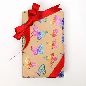 Rainbow gradient butterfly gift wrap roll with a decorative red ribbon bow