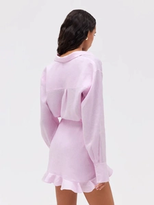Detail view of pink cotton linen shirt dress with back pleat and ruffle hem skirt