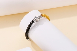 Detail view of two-tone stainless steel chain bracelet with spherical magnetic clasp