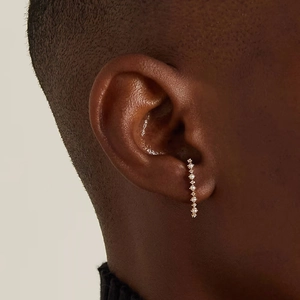 Close-up of S925 silver ear cuff with alternating pearls and zircon stones on model