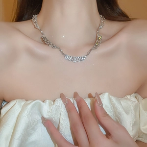 Elegant silver teardrop necklace with shimmering cubic zirconia on model's neck