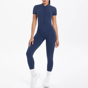 Close-up of sleek dark blue athletic bodysuit featuring a zipper and stand-up collar design