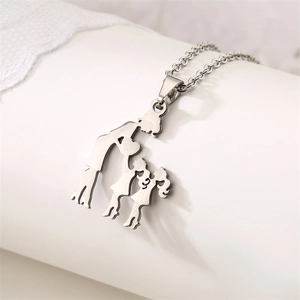 Detail of silver stainless steel pendant depicting a mother and children with polished finish