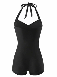 Detail view of black halter-neck one-piece swimsuit with lace-up straps and heart neckline