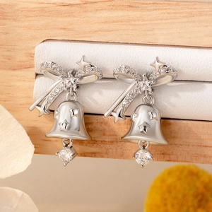 Silver Christmas bell earrings with crystal bow and star details on display stand