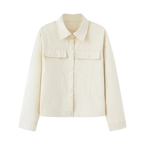 Detailed view of beige French vintage jacket with front flap pockets and buttons