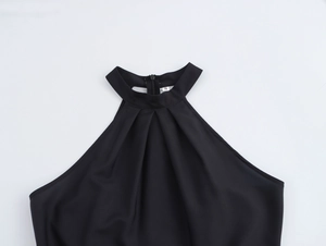 Close-up of halter neckline on black vintage dress with size S label and zipper detail
