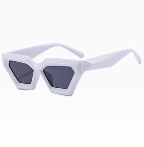 Detail view of bold geometric white hexagonal sunglasses with dark tinted lenses
