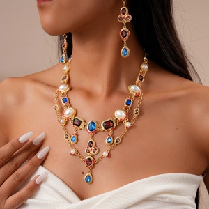 Vintage multi-layer jewelry set with faux pearls, ruby gems, and blue crystals on gold