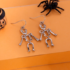Detailed view of silver skeleton earrings with pumpkin and spider Halloween decor