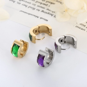 Detail of gold and silver stainless steel earrings with purple and green rectangular gems