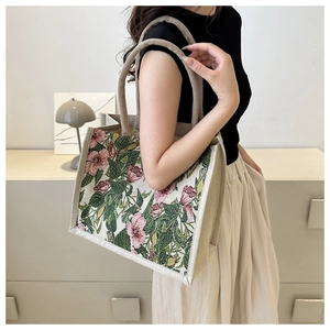 Detail of vintage floral tapestry on a large linen tote bag with cream rounded handles