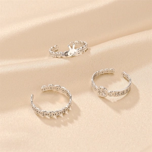 Detailed view of silver titanium steel rings with rabbit motif and Chinese characters