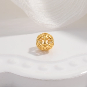 Macro shot of a hollow gold-plated S925 sterling silver barrel bead for DIY jewelry
