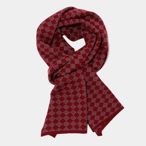 Detailed view of red and white diamond pattern knitted scarf with premium texture