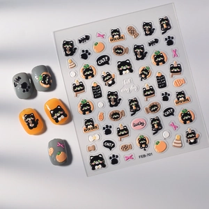 Detail of 3D embossed nail stickers featuring black cat, pumpkin, and fish patterns
