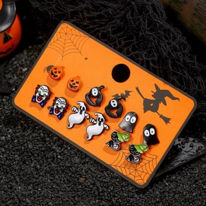 Halloween earring set featuring pumpkin, ghost, and bat designs on themed display card