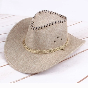 Close-up of beige straw cowboy hat with black stitching, metal vents and decorative rope