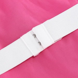 Detail of the pink fabric, white elastic band and metal hook closure on the dress