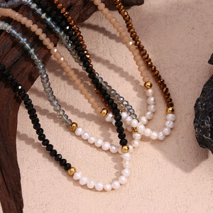 Detail of freshwater pearls and faceted crystals on a handcrafted beaded necklace